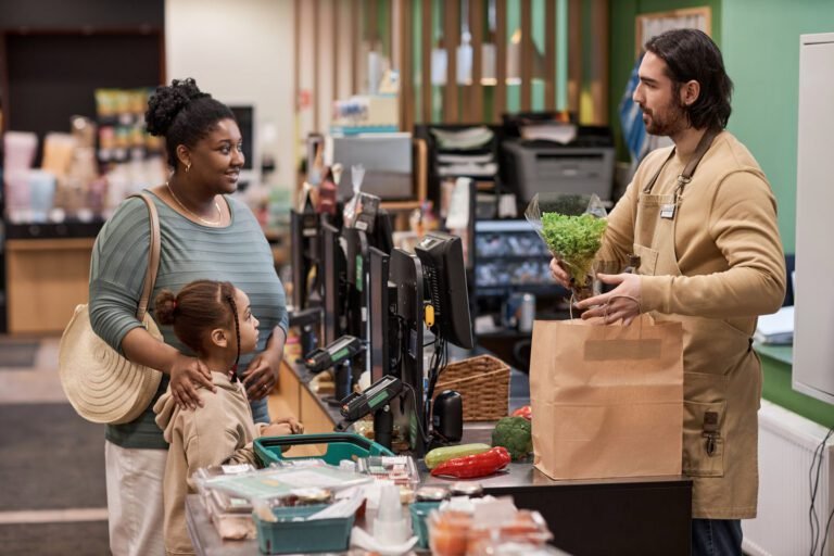 Black young mother with little girl buying groceries in supermarket