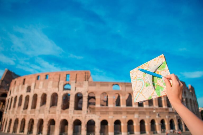 Closeup touristic map and toy airplane on Colosseum background. Italian european vacation in Rome. Concept of imagination