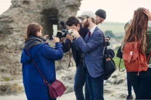 men-photographing-woman-holding-smart-phone-at-bea-2024-10-18-07-05-08-utc