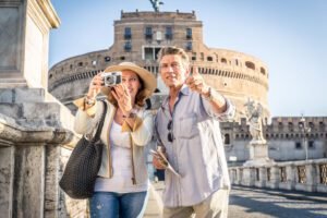 Senior couple at Castel Sant' Angelo, Rome - Happy tourists visiting italian famous landmarks