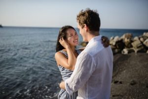 Young couple walking on the background of the sea on the island of Santorini