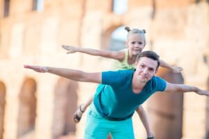 Young father and little girl background Colosseum, Rome, Italy. Family portrait at famous places in Europe