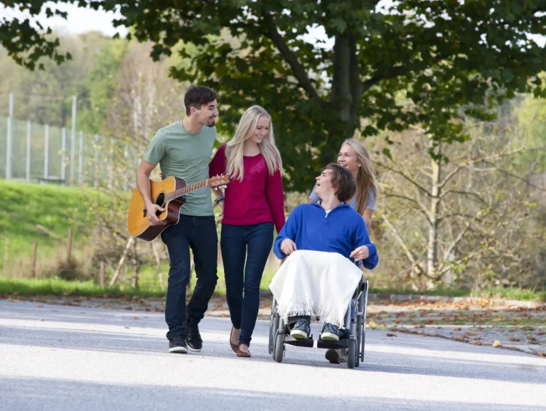 young-man-in-wheelchair-with-friends-2024-09-15-17-39-28-utc