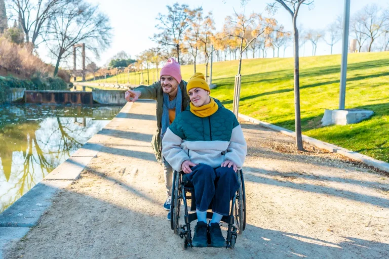 young-man-pushing-friend-in-wheelchair-showing-so-2025-01-16-02-34-25-utc